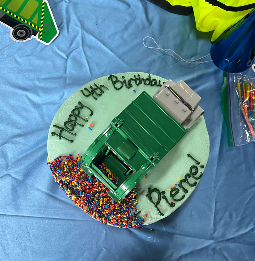 Birthday cake with a garbage truck theme.