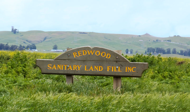 Wood Sign for Redwood Sanitary Land Fill Inc in grass meadow