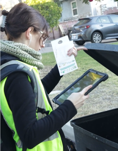 A Race to Zero Waste Auditor looks inside a cart